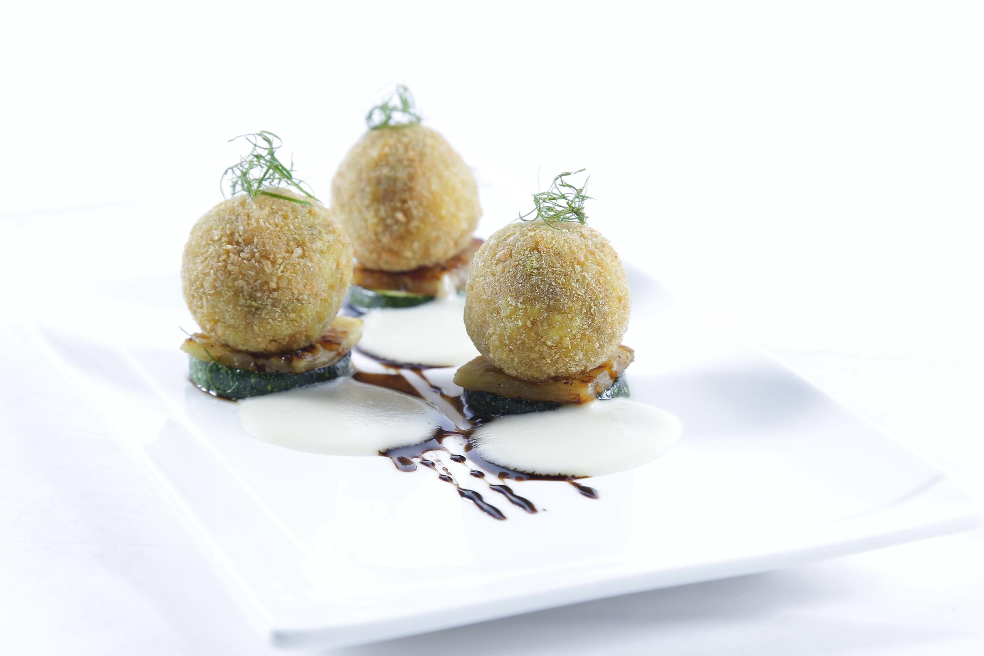 Stack of plated desserts with gold leaf